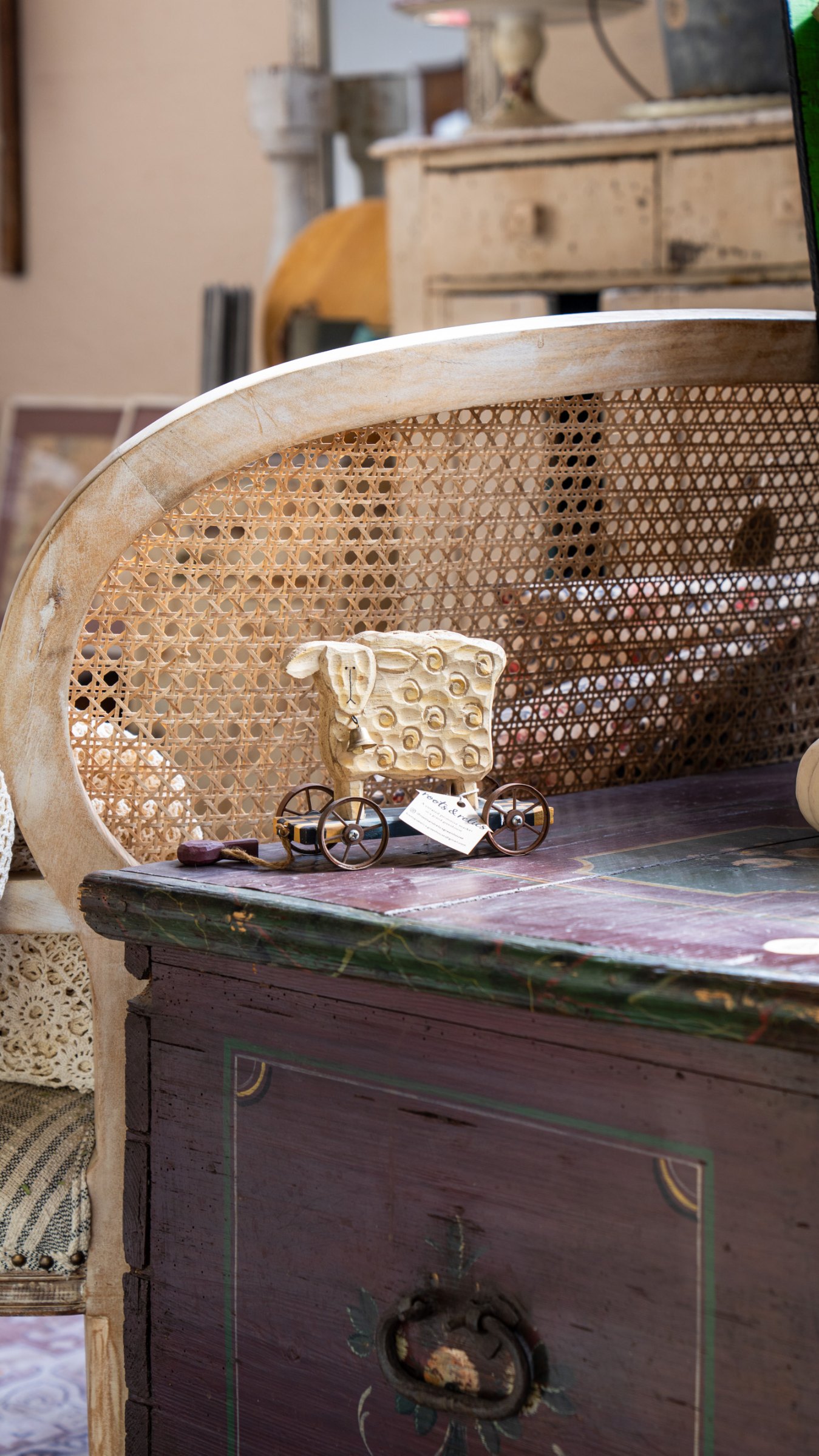 Woven basket and framed artwork on an antique dresser