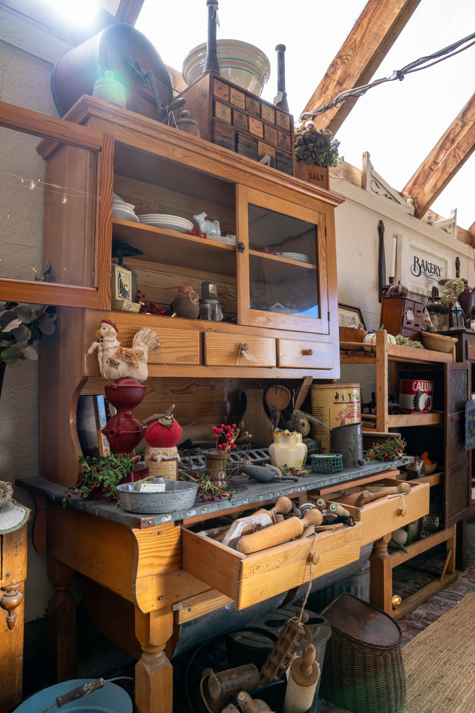 Wooden hutch displaying glassware and vintage kitchen pieces