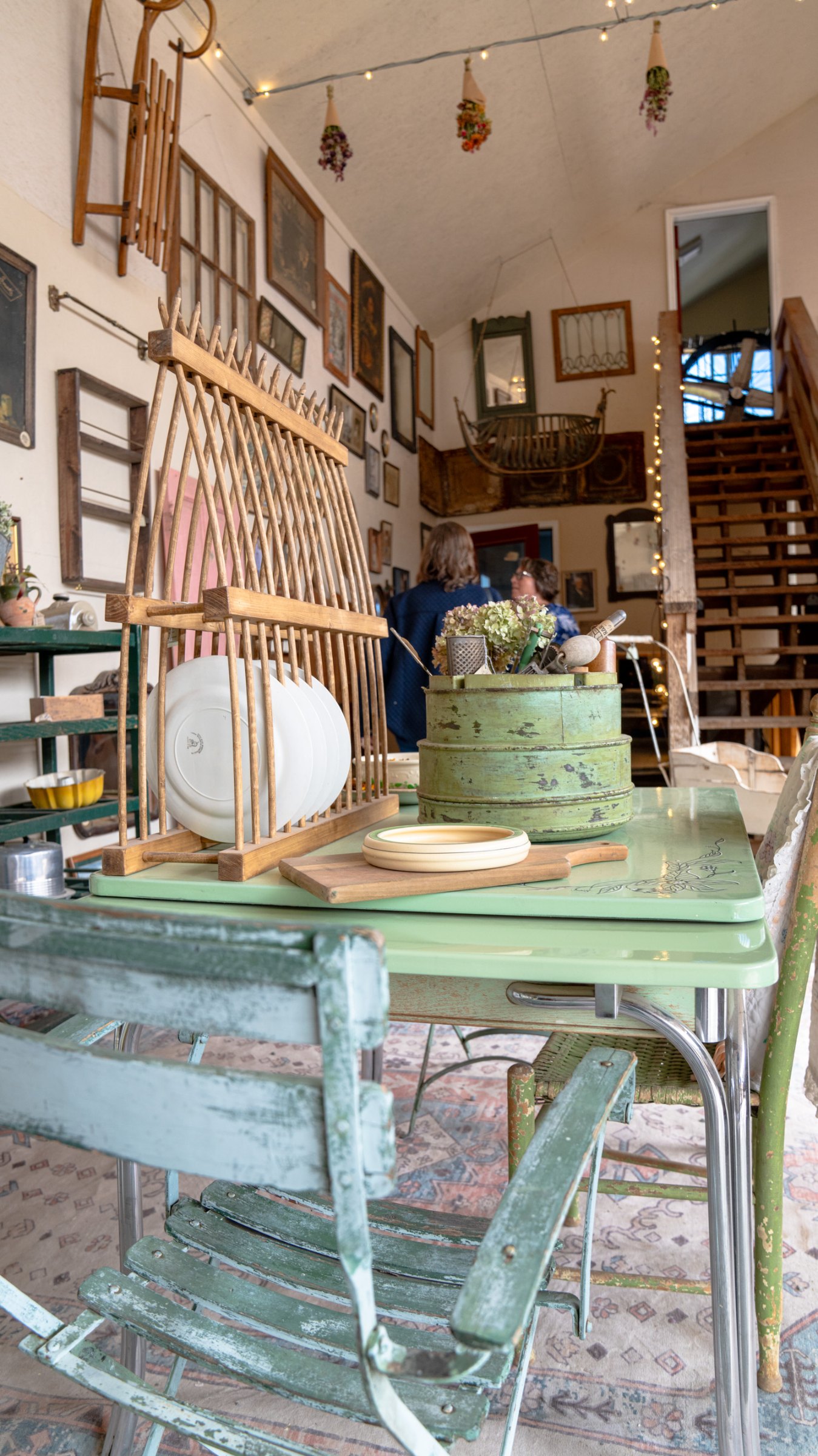 Green painted table and chairs inside the greenhouse