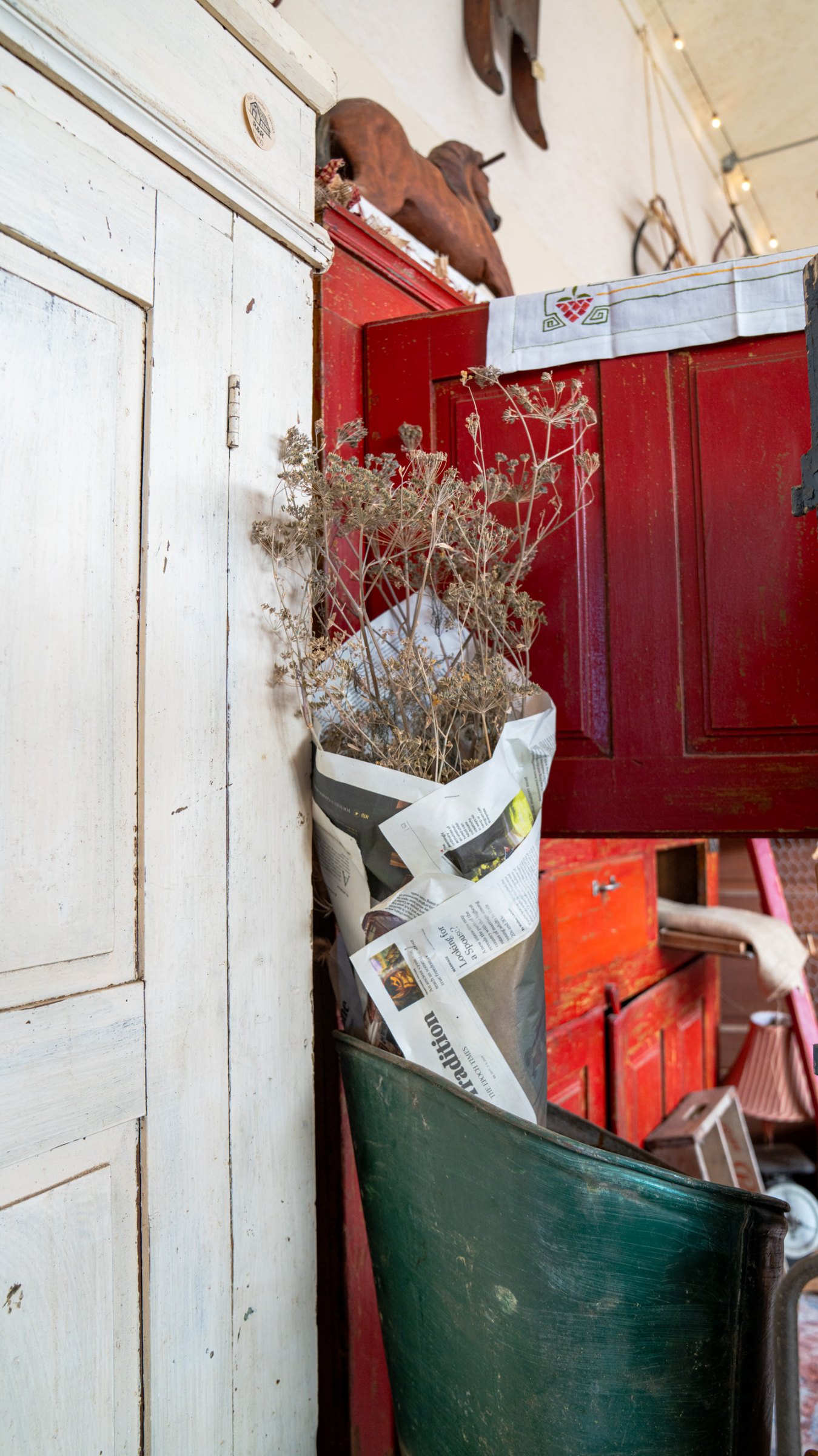 Dried flowers and red shutters in a greenhouse display