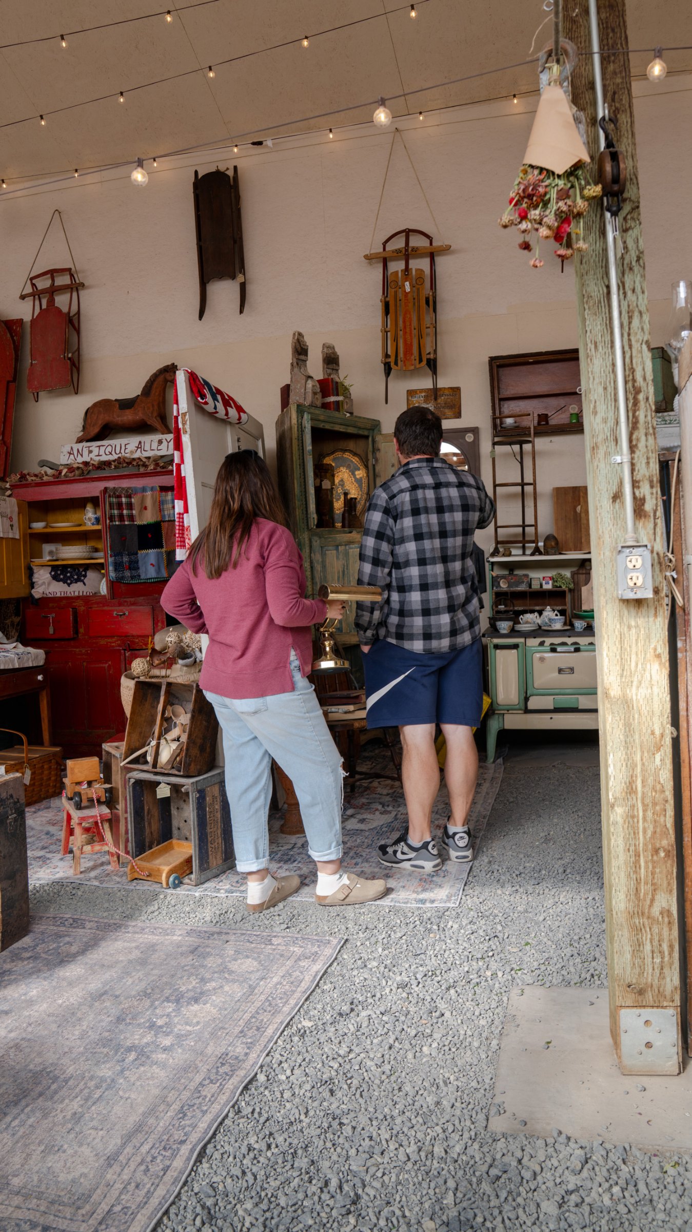 Visitors browsing furniture and vintage wall displays