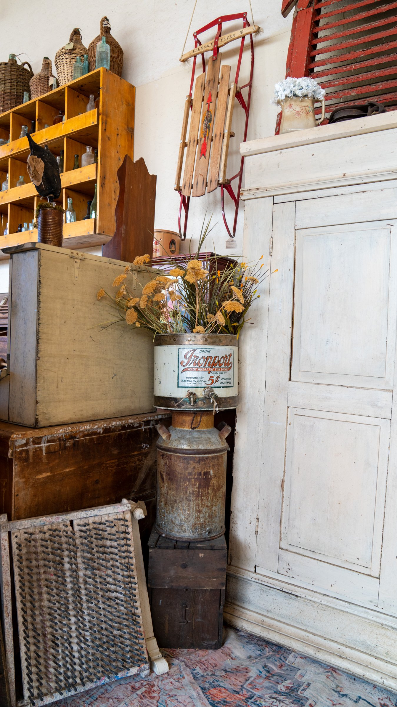 Painted cabinets and shelves filled with vintage treasures
