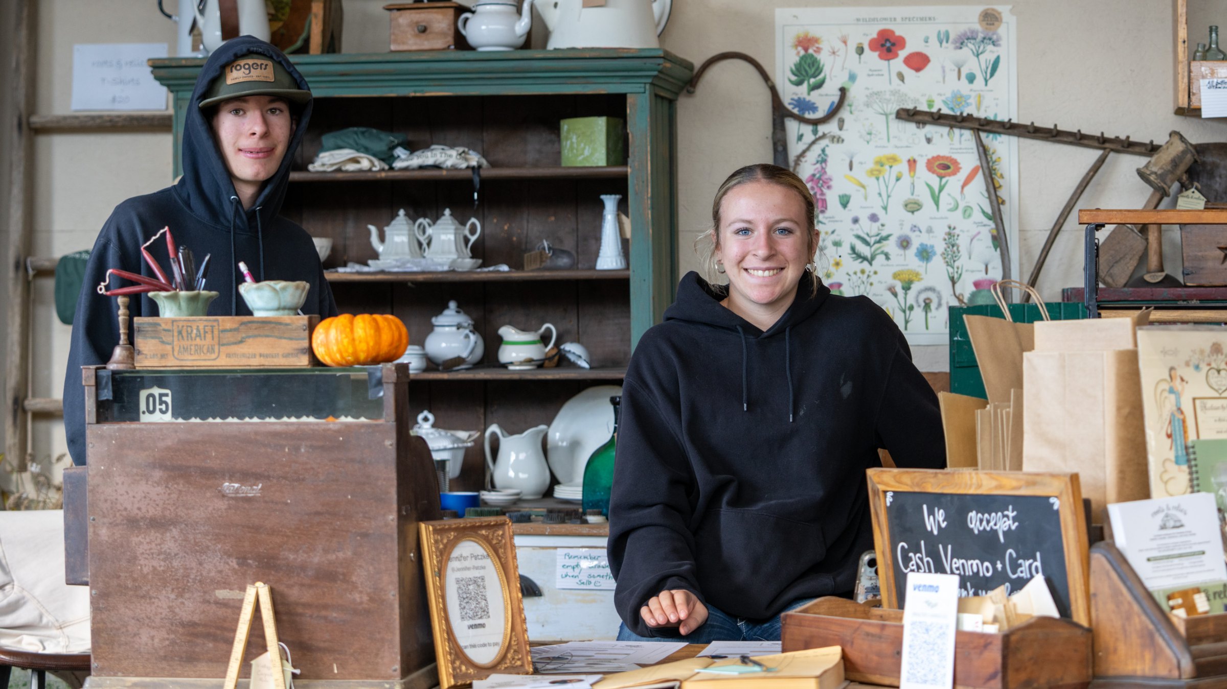 Smiling people at the counter among autumn decorations