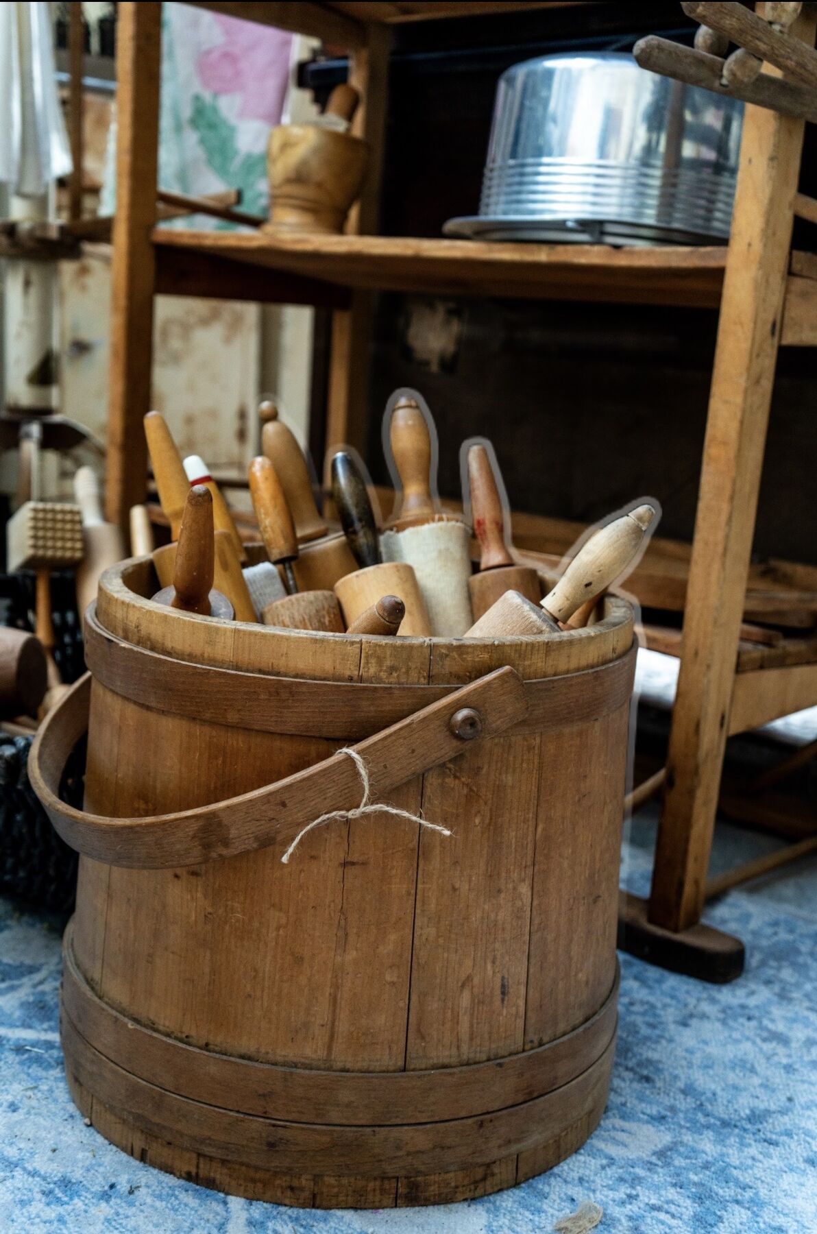 Antique wooden kitchen tools gathered in an old wooden firkin