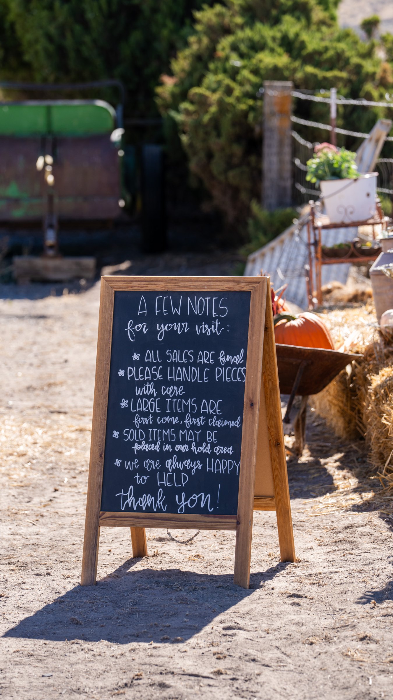 Chalkboard gathering sign beside the outdoor displays
