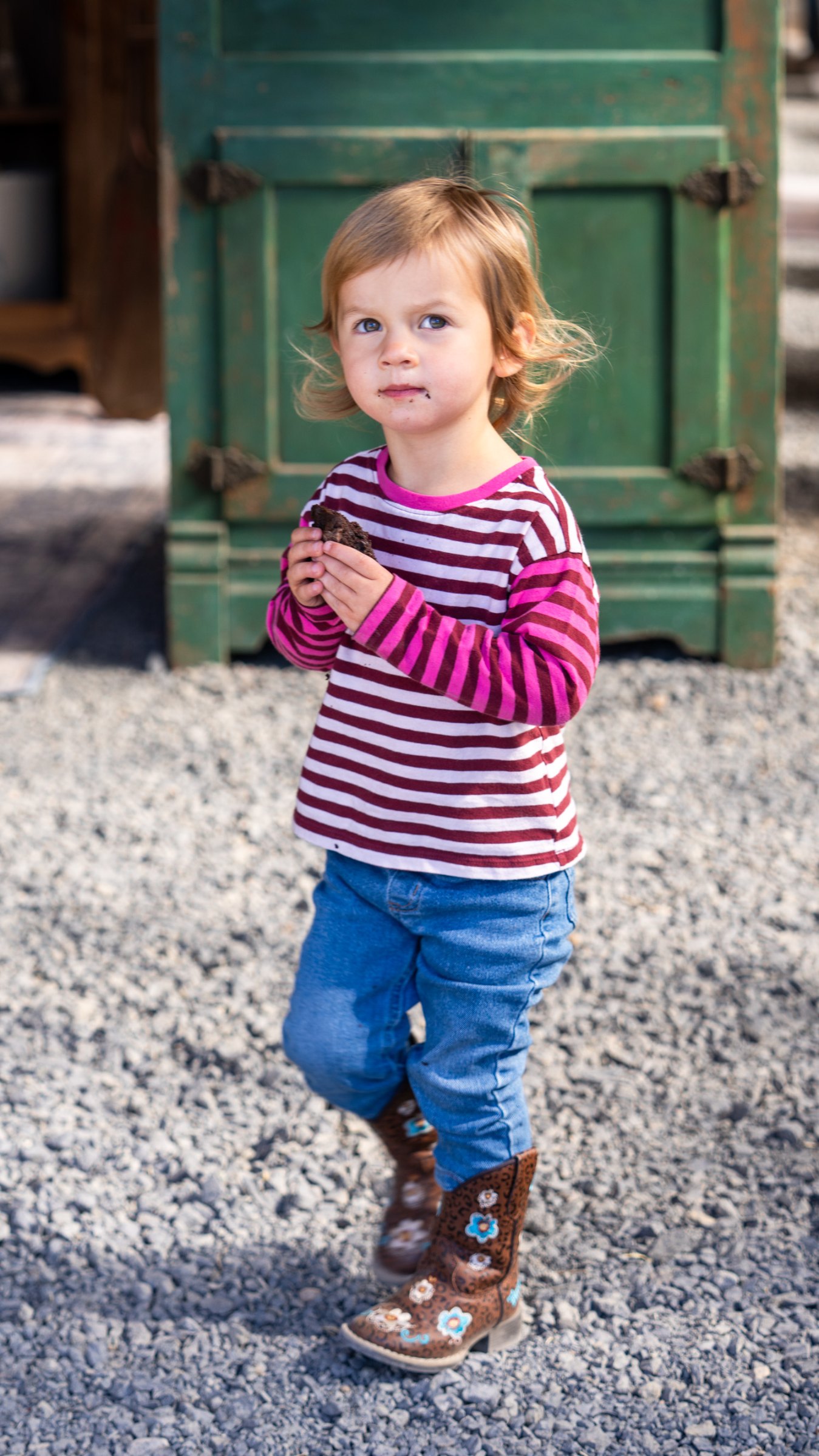 Young visitor standing outside the greenhouse