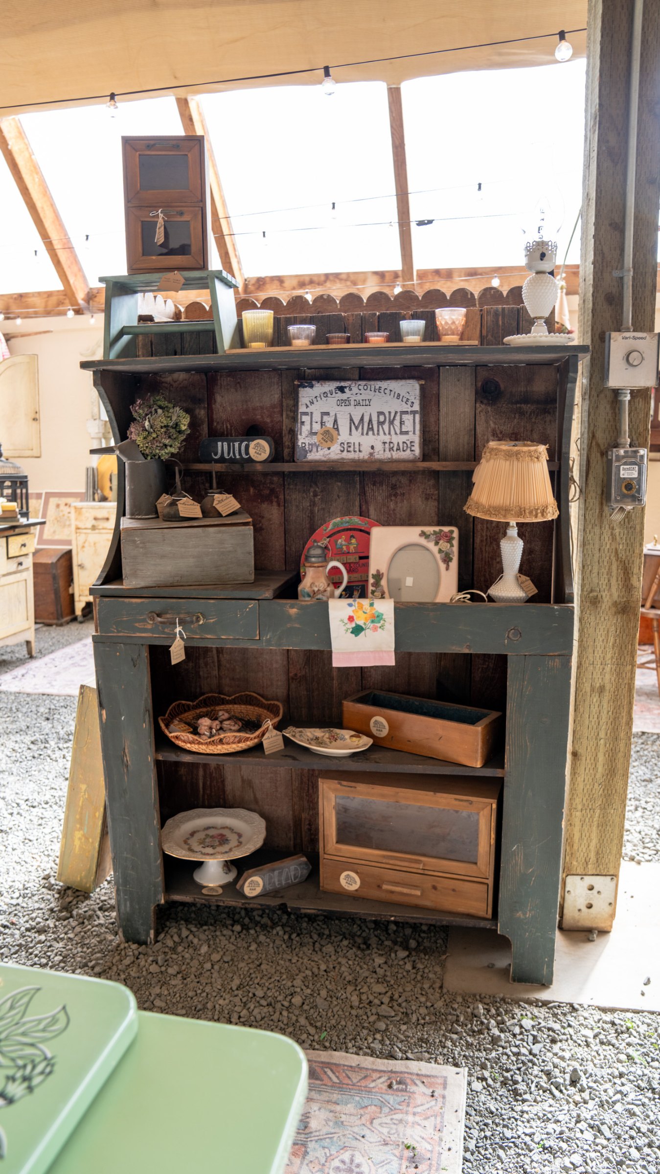 Antique stove and kitchen display beneath a window