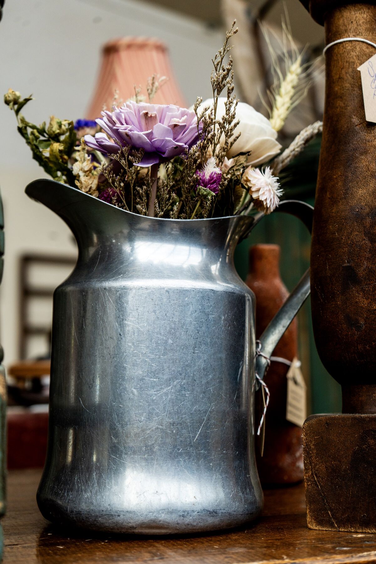 Dried flowers gathered in a vintage metal pitcher