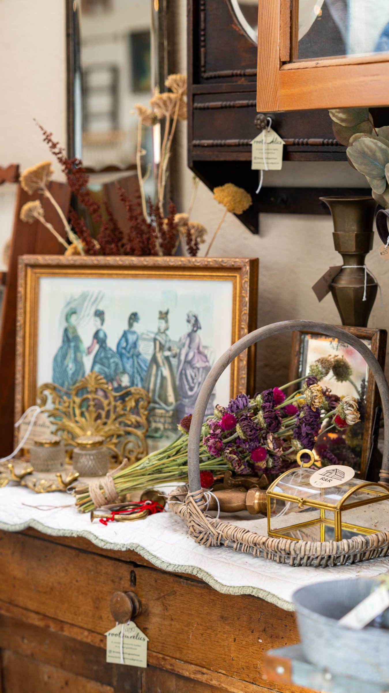 Framed landscape and autumn decorations on a sideboard