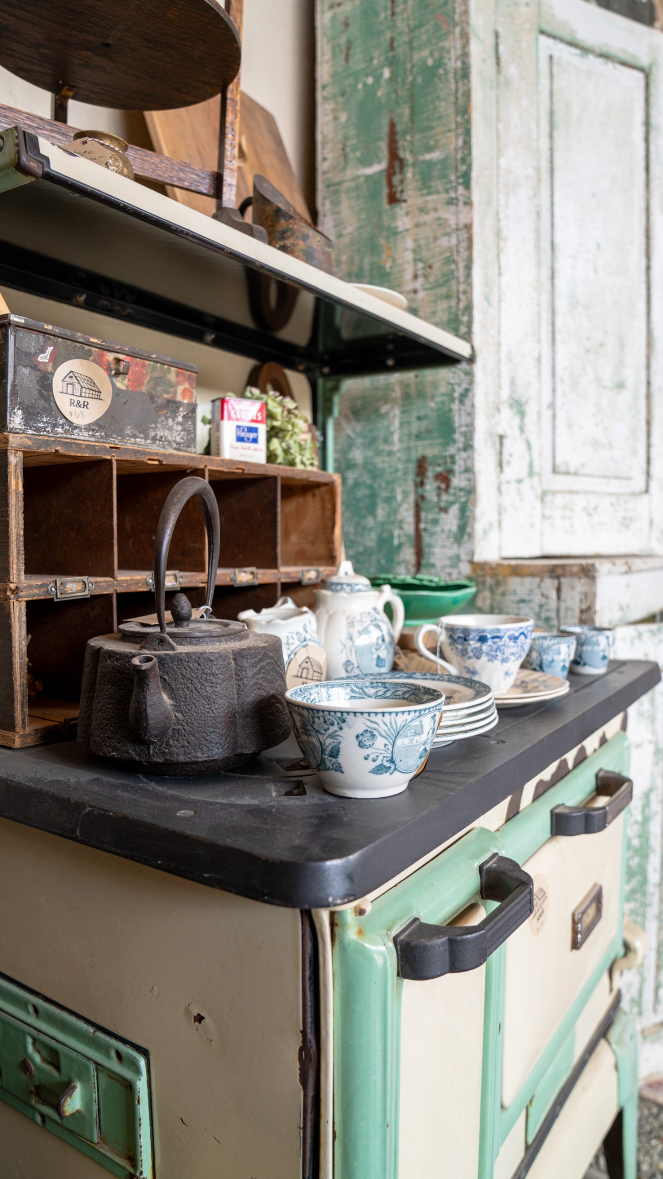 Vintage green stove with pots and enamelware