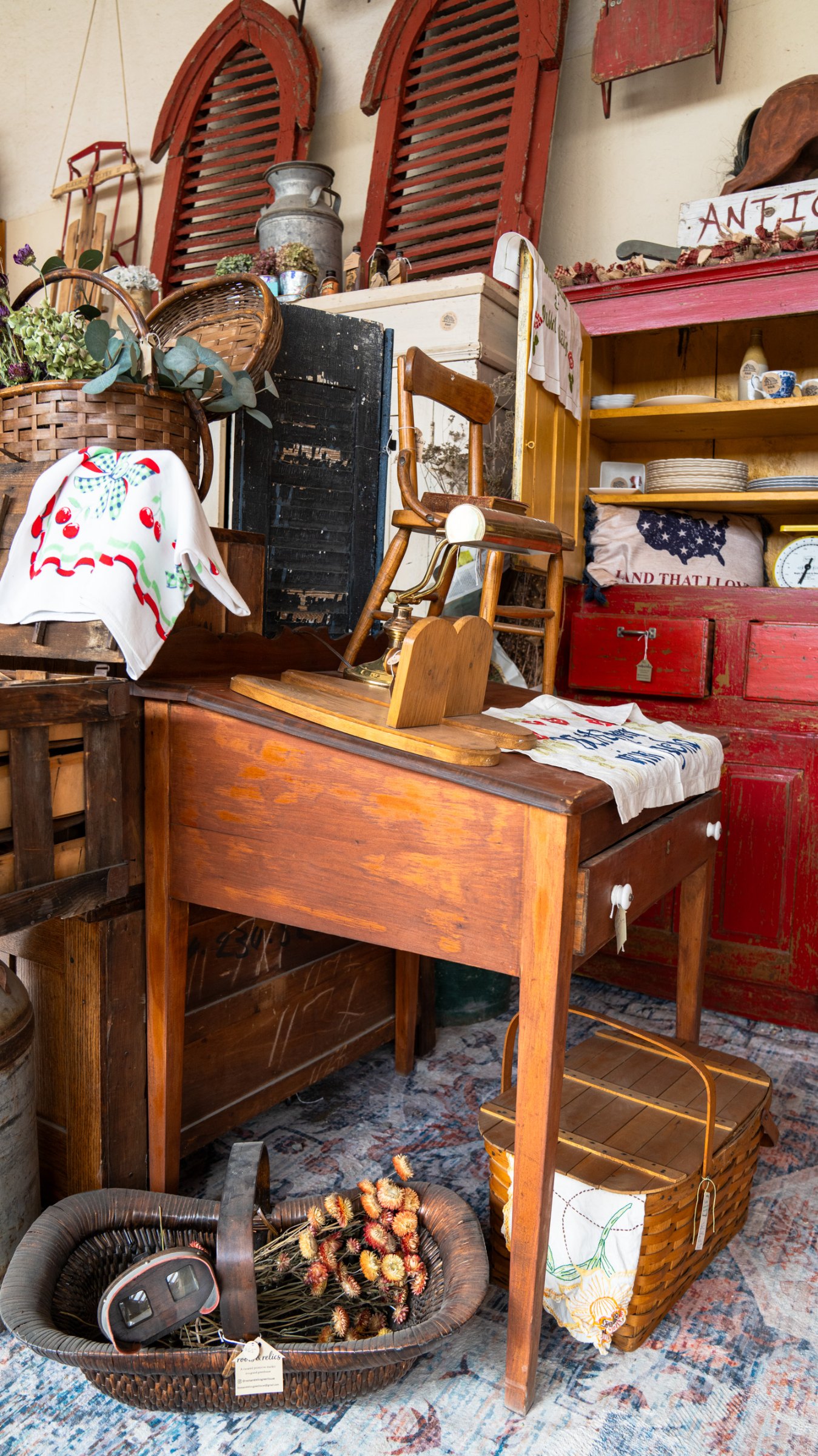 Wooden desk and shelves filled with vintage kitchenware